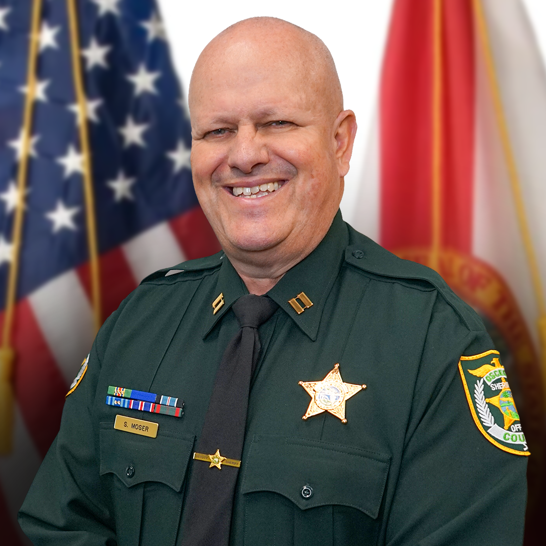 Portrait of Captain Steve Moser of Special Operations, smiling and wearing a dark green Osceola County Sheriff’s Office uniform.